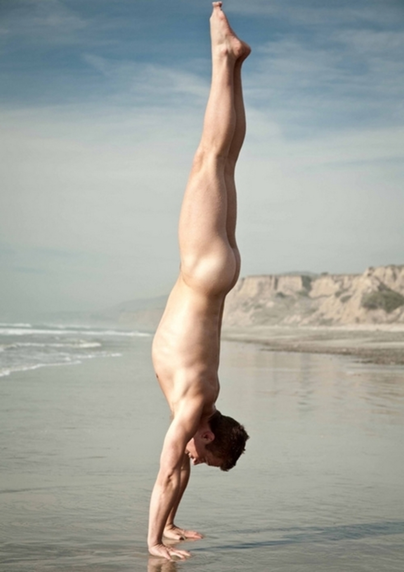 Naked handstand man